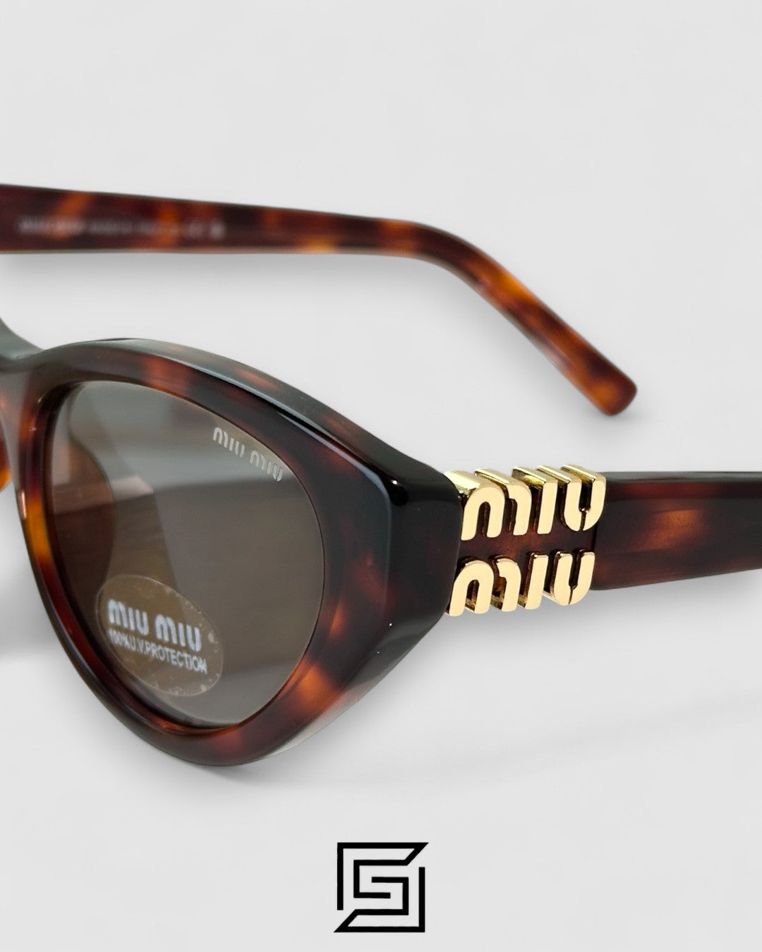 Miu Miu MUA04 21C40 Light Grey Lenses and Tiger Brown Frame With Gold Logo