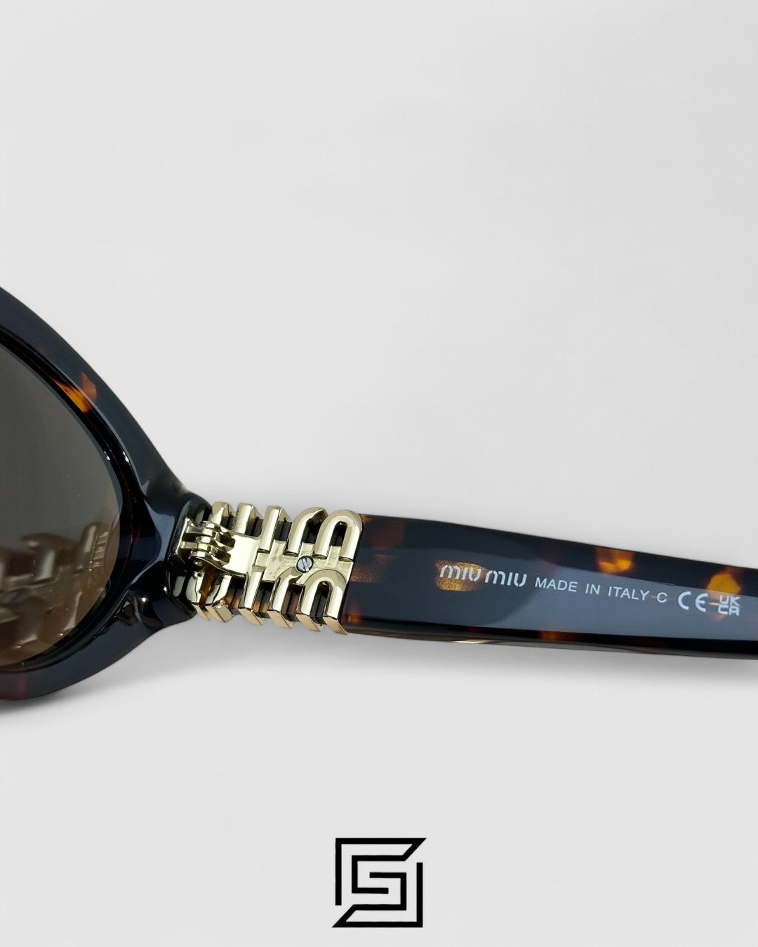 Miu Miu MUA04 14L60M Brown Lenses and Tiger Brown Frame With Gold Logo