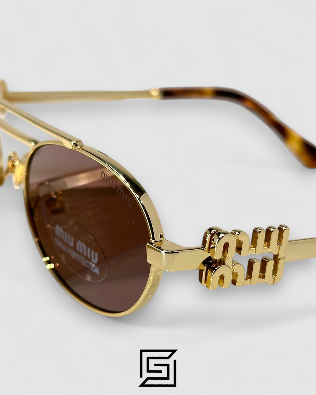 عدسات Miu Miu MU54ZS بنية وإطار ذهبي