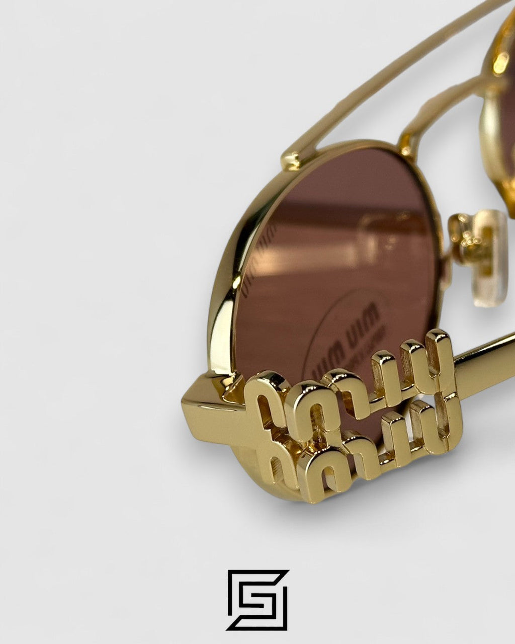 عدسات Miu Miu MU54ZS بنية وإطار ذهبي